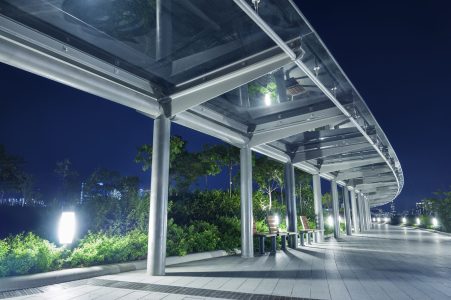 Empty pedestrian walkway in park at night